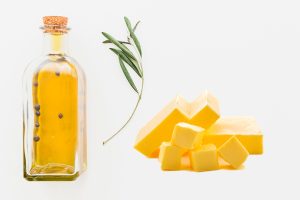 Botella de aceite y porciones de mantequilla